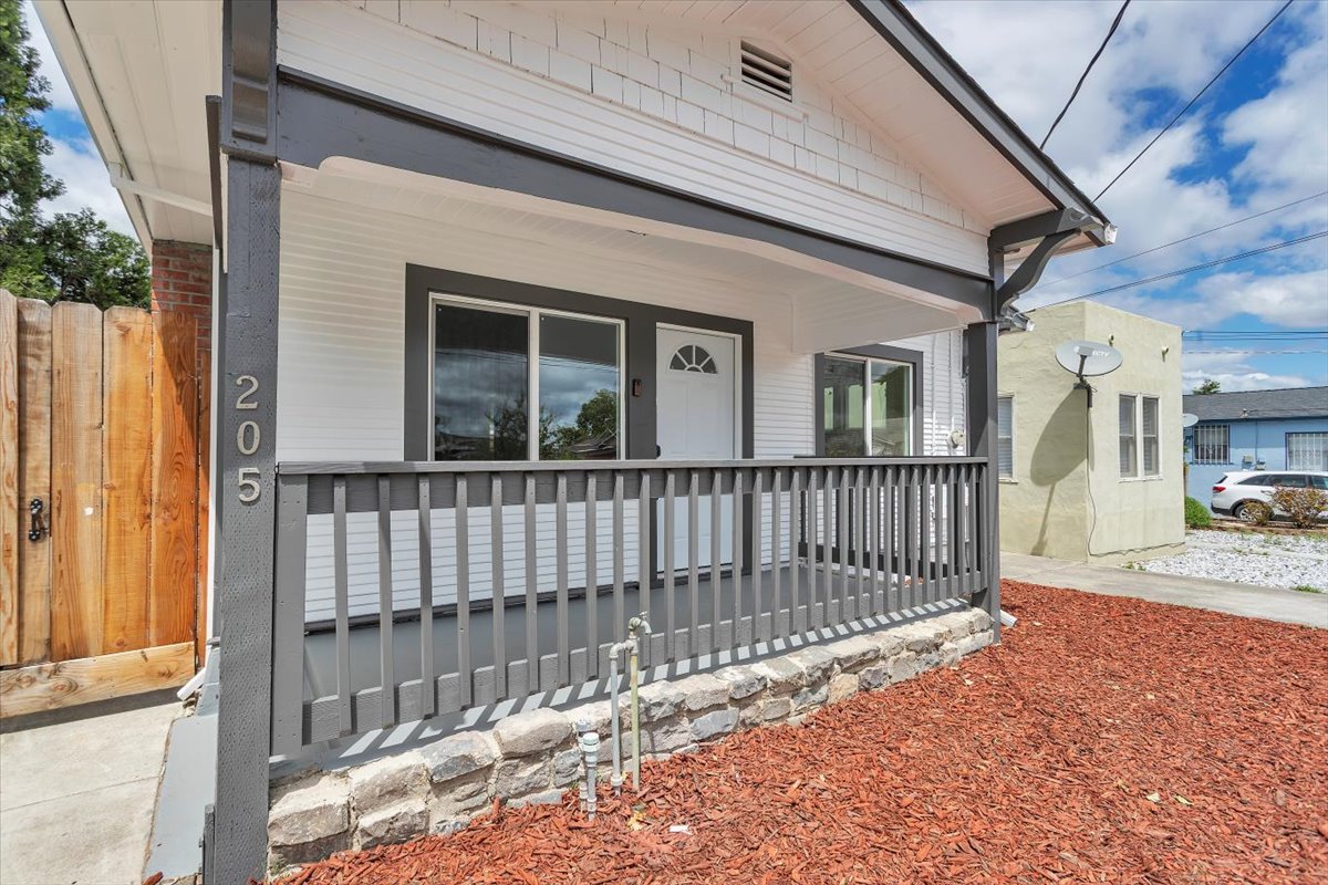 Exterior of the same Oakland property after renovation — freshly updated with modern curb appeal, new paint, and improved landscaping.