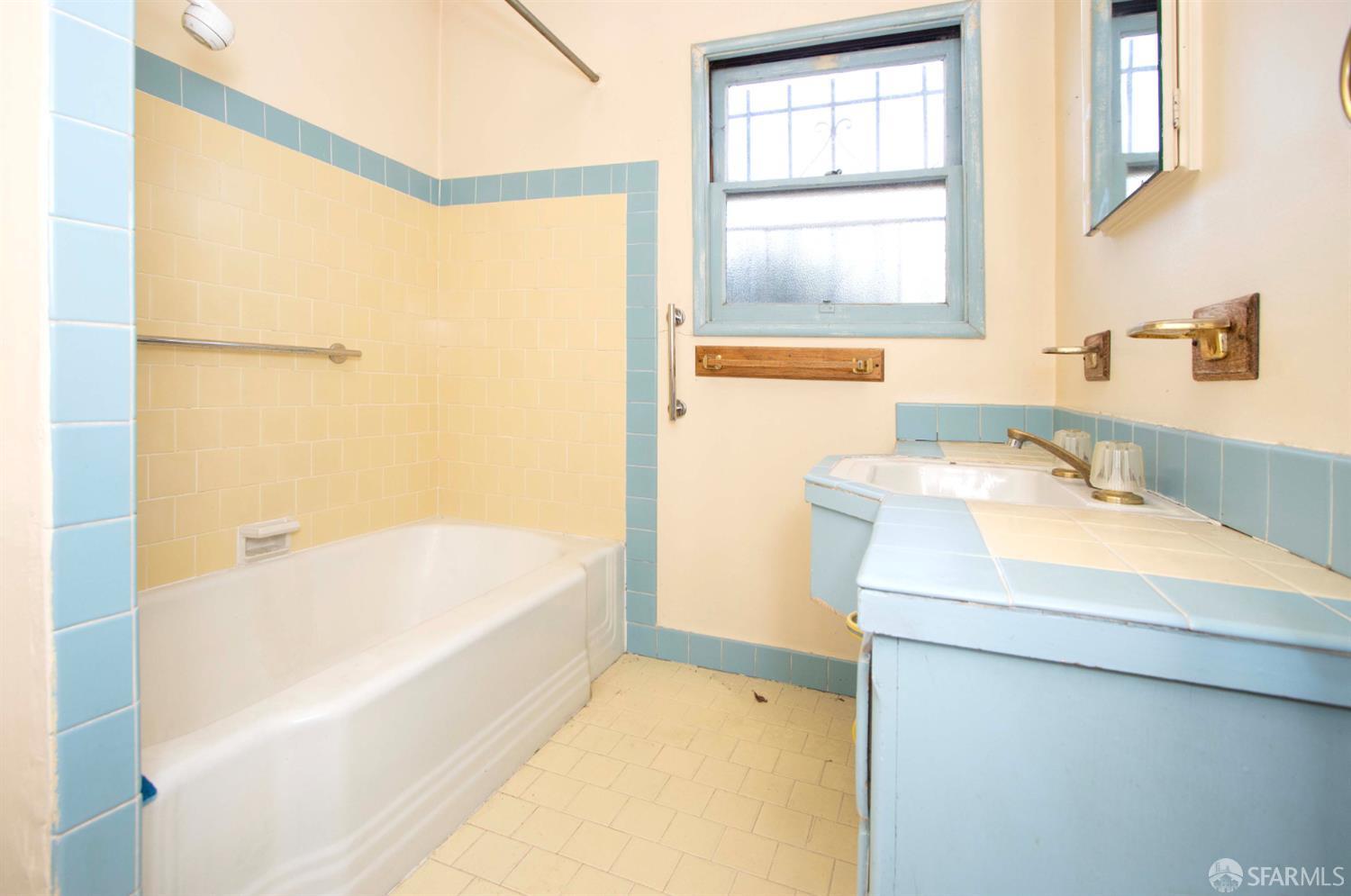 Oakland Hills bathroom before renovation — old blue tile and yellow walls